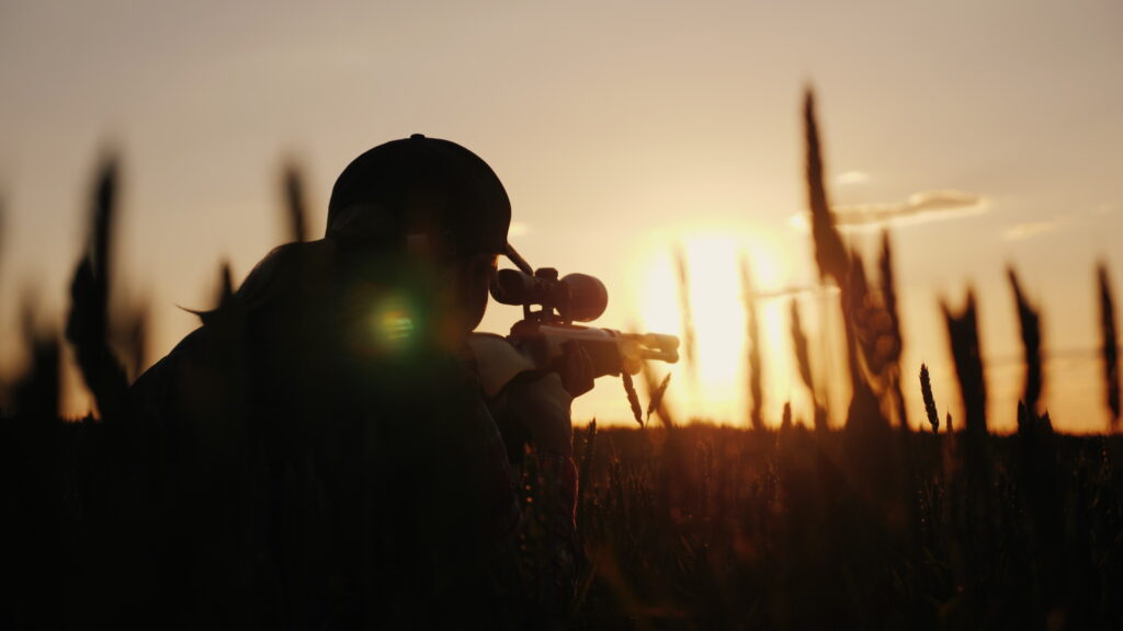 A sniper rifles from a rifle with an optical sight. On the Sunset. Sports shooting and hunting concept.